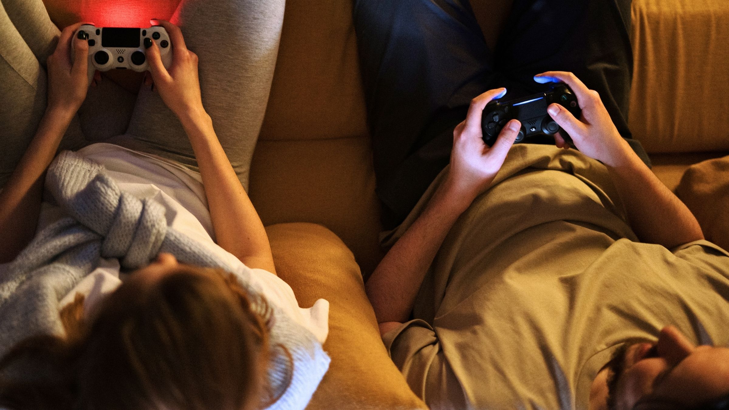 Couple on the couch with controllers, shown from above